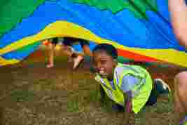 children playing parachute games on a field