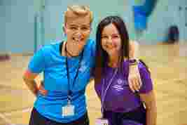 JAG staff smiling together in a sports hall