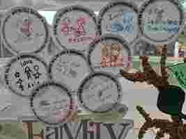 Paper circles with drawings and messages like "Love All" and "I will care for others" are displayed for National Reconciliation Week.