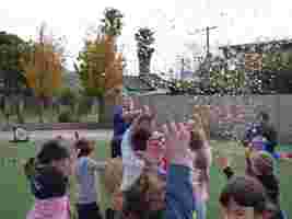 OSHC educator popping confetti with kids
