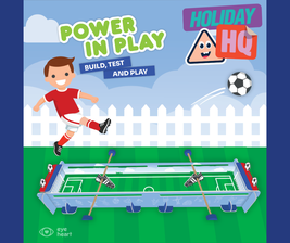 Cartoon boy kicking a soccer ball towards a mini football field game. Text: "POWER IN PLAY," "BUILD, TEST AND PLAY," "HOLIDAY HQ."