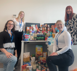 The Content Guru team poses next to foodbank donation