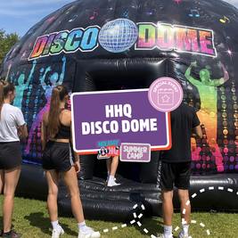 People standing outside an inflatable "Disco Dome" decorated with colorful graphics at a summer camp event.