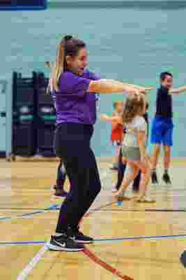 JAG staff dancing in a sports hall