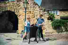 Man and woman standing next to their bikes