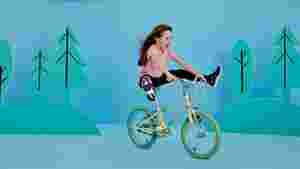 A girl riding a Raleigh POP Kids bike