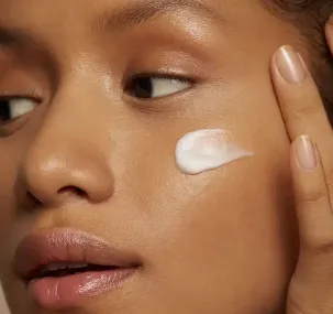 A user with some lotion on their face
