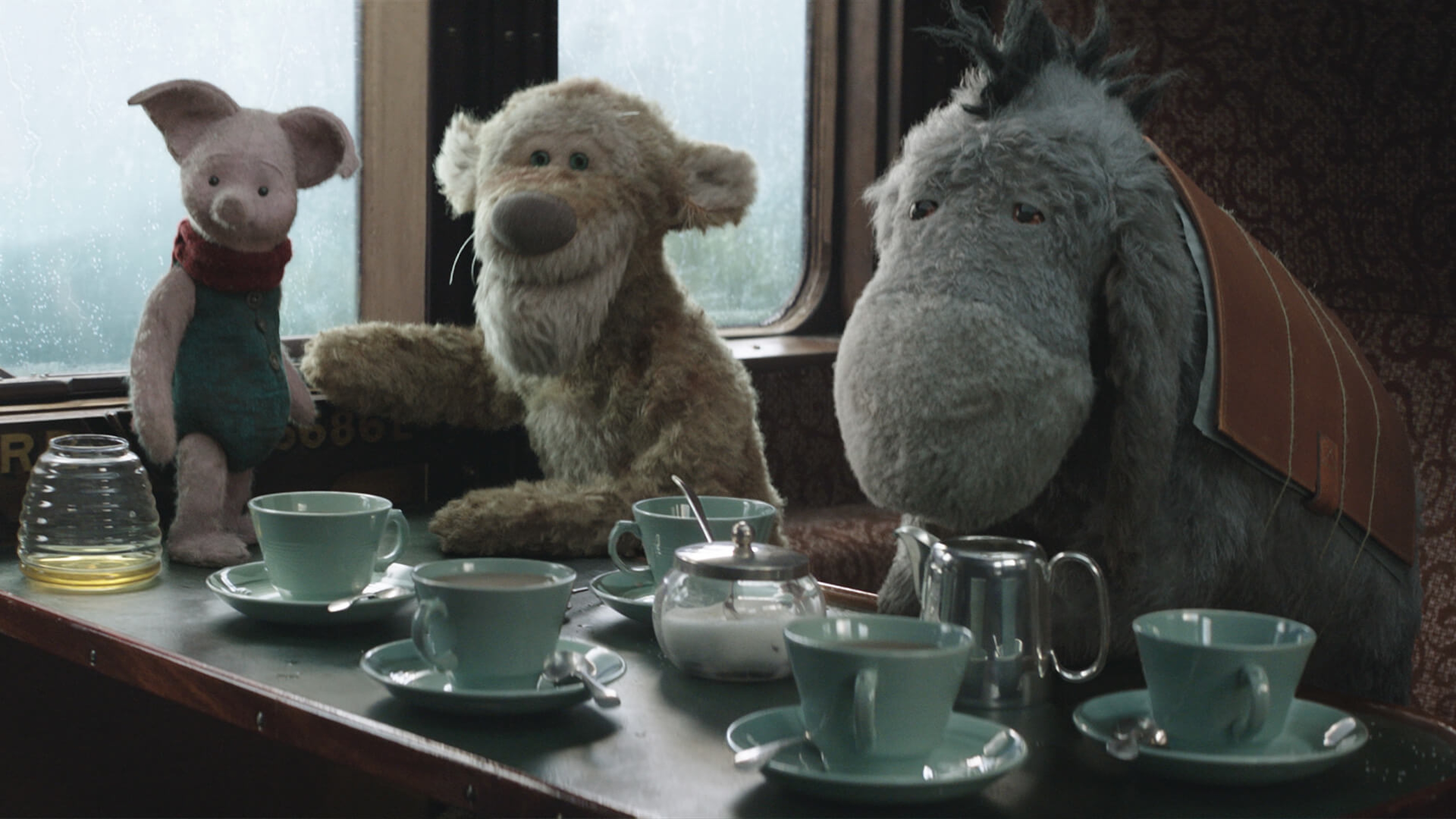 Animated characters of Piglet, Tigger and Eeyore having tea