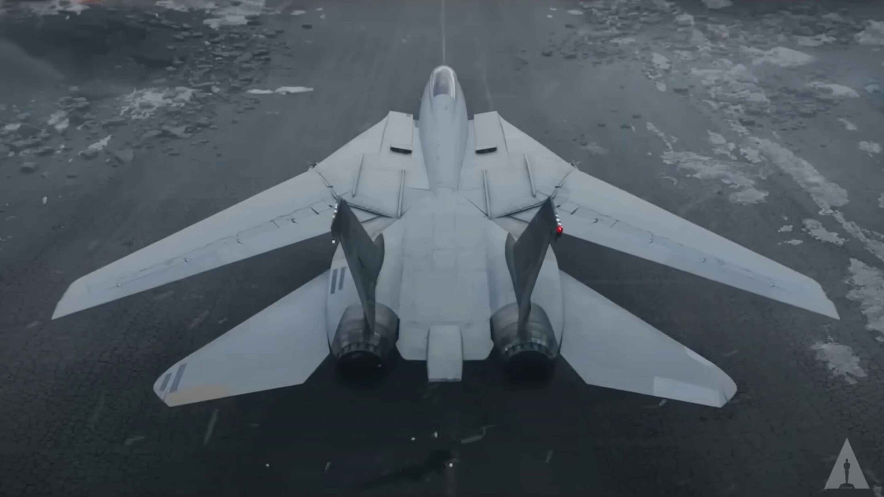 A grey fighter plane featured on Top Gun:Maverick on a snowy runway