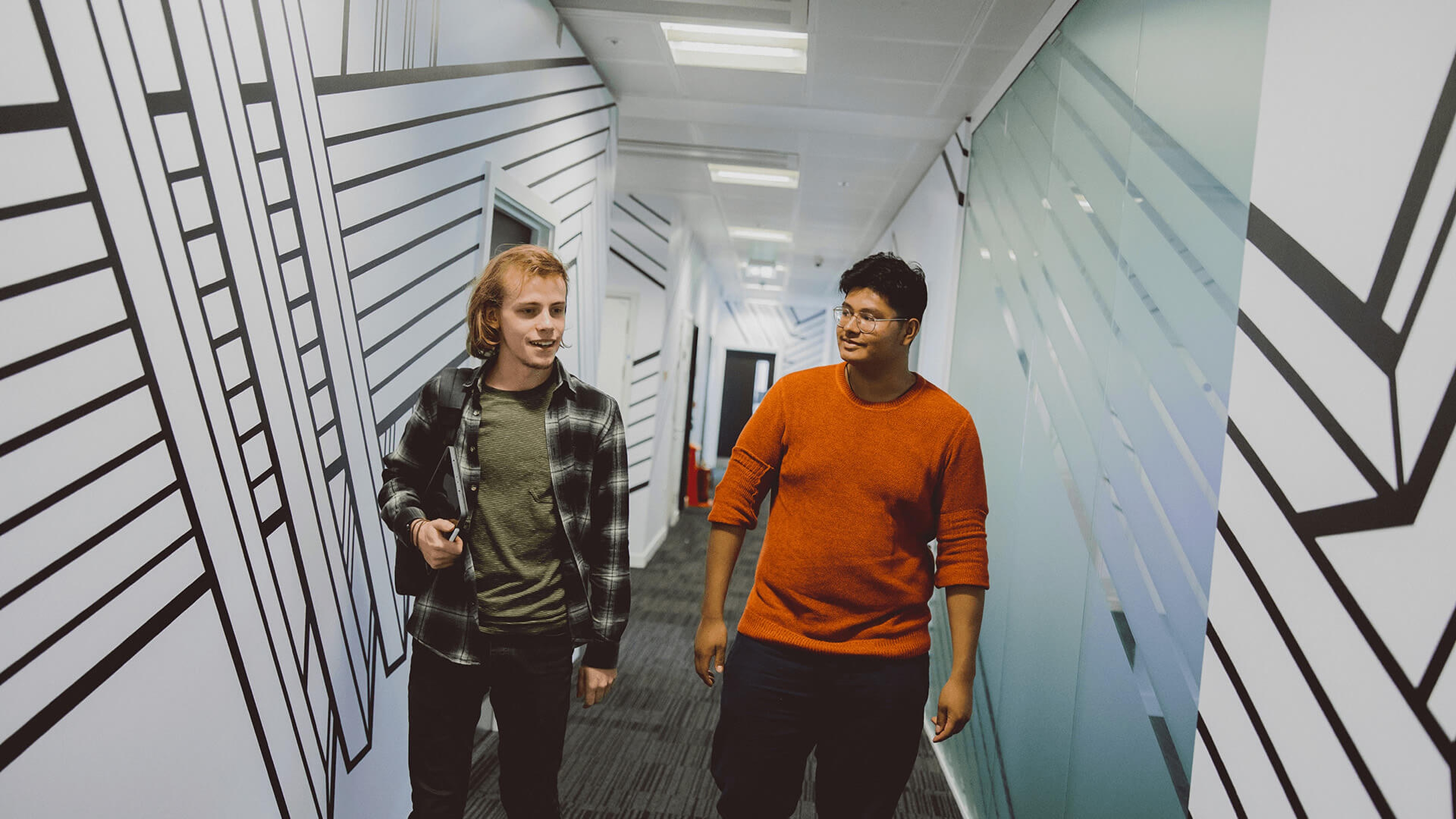 Pair of students walking down a corridor at Escape Studios