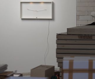 mechanised edition hanging on warehouse wall, boxes are stacked in the foreground