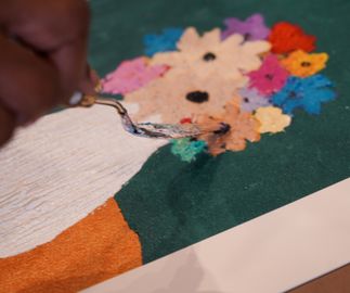 close-up of paint being applied to a flower via palette knife