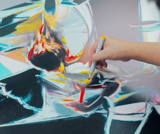 Jia AIli hand-finishing a print with yellow marker pen