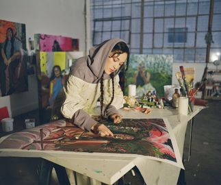 Gisela McDaniel hand finishing her prints in her studio 