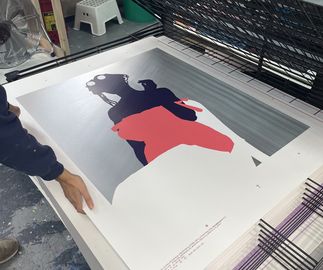First layers going down on drying rack at print studio, outline of a woman evolving