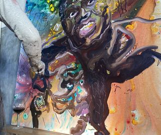 artist Ludovic Nkoth painting a big canvas painting in his studio - close up