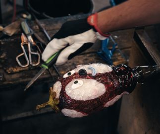 Joakim glass blown head being edited at foundry