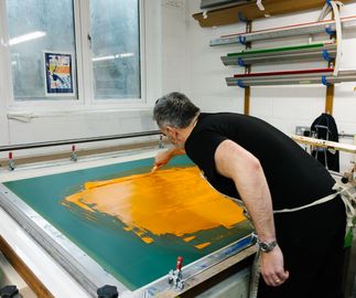Michael Kagan working on a silkscreen print at a print house