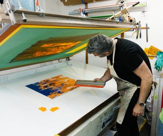 Michael Kagan working on a silkscreen print at a print house