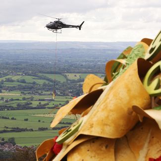 Helicopter carries giant nacho through Cheddar Gorge for Doritos new record for the world’s highest ever cheese pull at 49 feet high