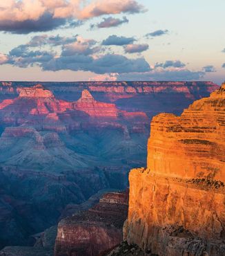 red canyons lit up at sunrise in the grand canyon