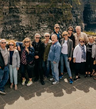 people gathered together at the cliffs of moher in ireland