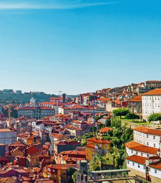 buildings along the duoro river in porto portugal on a sunny bright day