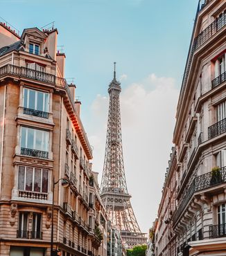 buildings on a street opening to the eiffel tower in paris france