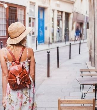 women tourist walking on street while traveling in europe