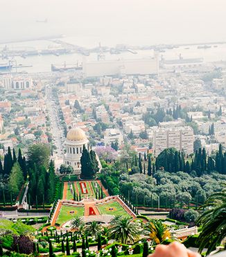 back of womens head looking down on bahaj gardens in haifa israel