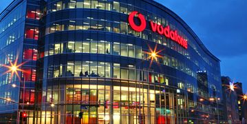 The Vodafone London offices are seen illuminated in the fading light