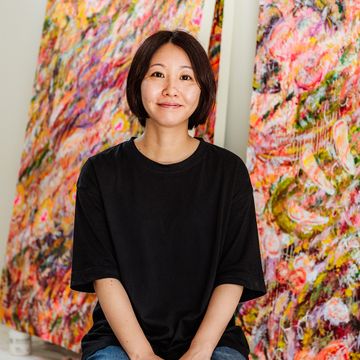 Ayako Rokkaku wearing a black T-shirt and smiling