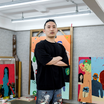 Artist Hyangmok Baik standing in his studio