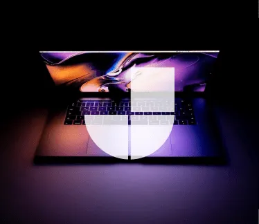 The Jamstack logo is overlaid on top of a laptop.