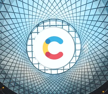 Contentful's logo is at the center of a glass roof in a building.