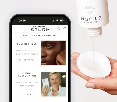 Mobile phone showing the Barbara Strum Website and a hand with a pouring a beauty serum on a cotton pad