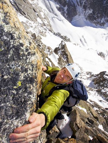 Andy Cane reaching up to grab hold of the above rock