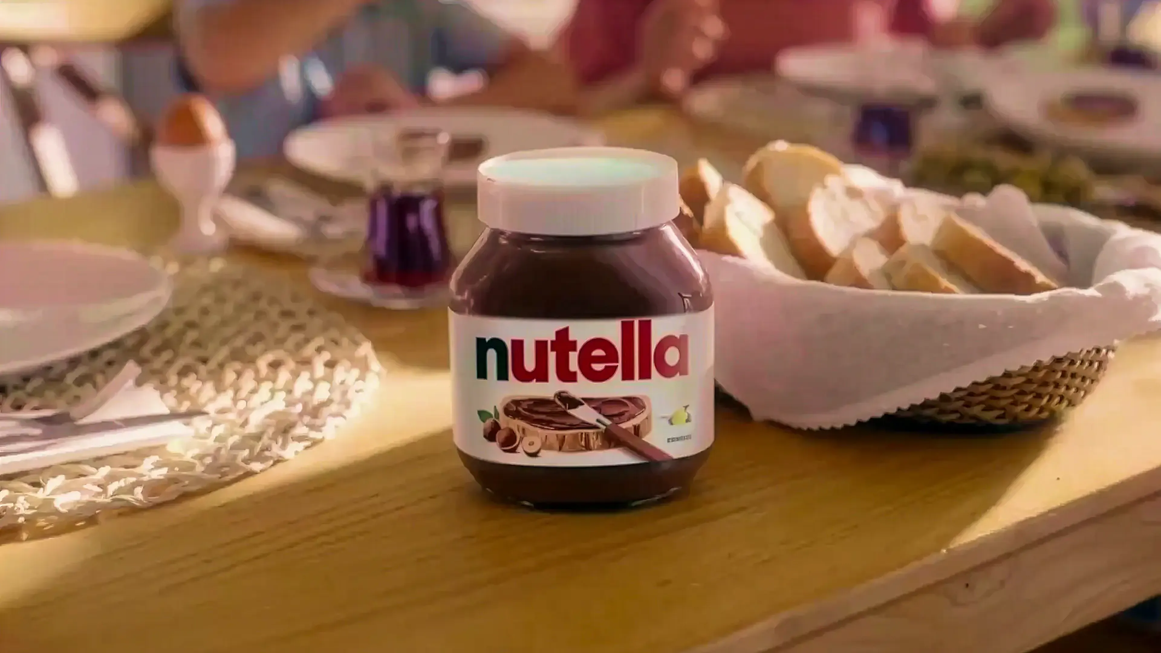 Jar of Nutella on a set breakfast table with plates and pastries, from the Sound of Nutella campaign