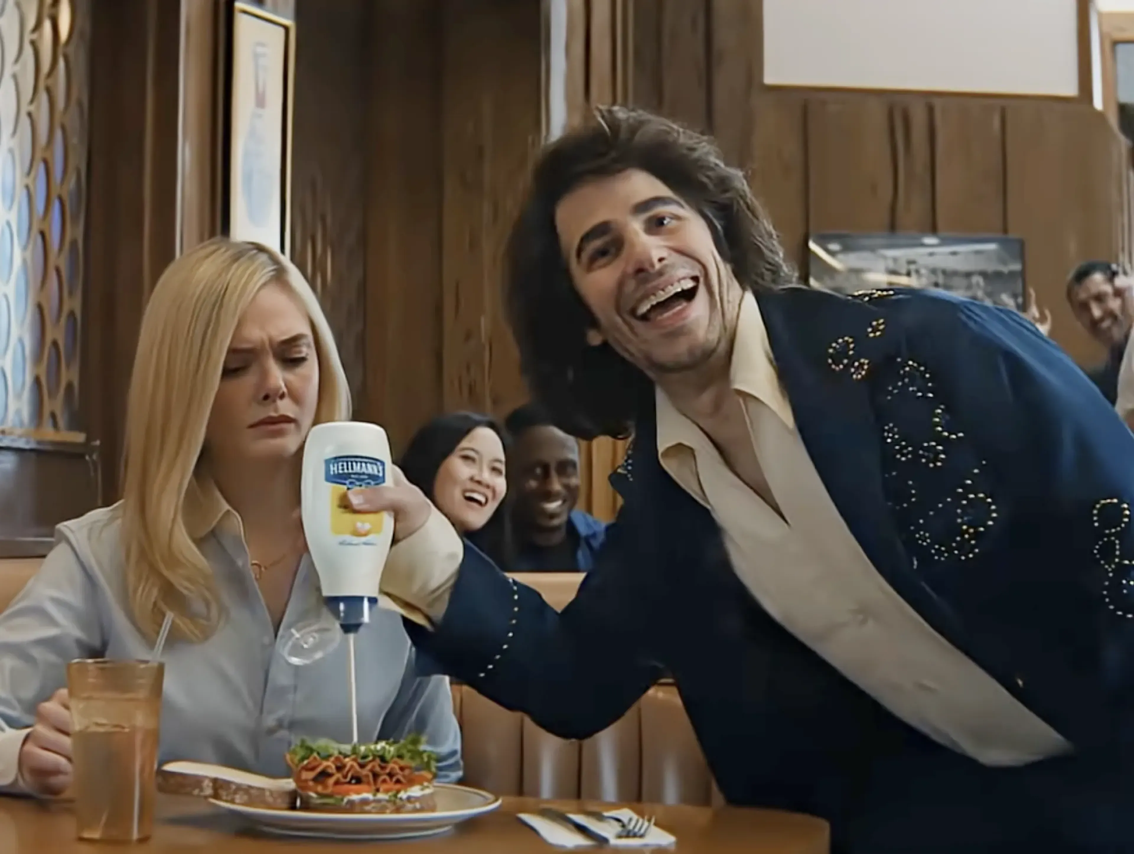 Meal Diamond squeezing Hellmann's mayonnaise onto a diner meal in the MassiveMusic Hellmann's Super Bowl campaign