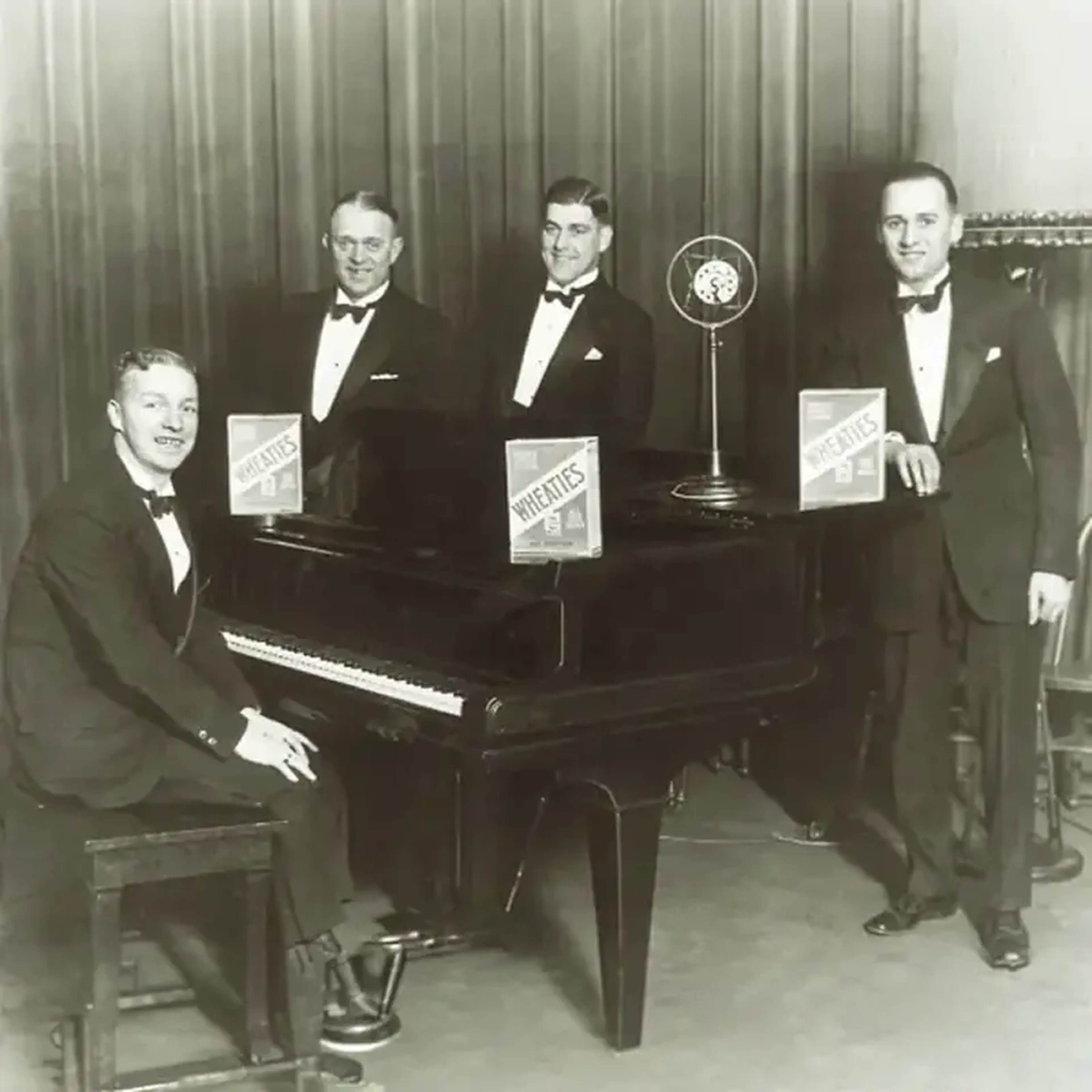 Vintage photo of the Wheaties quartet at a piano, singers of the first radio jingle in advertising history