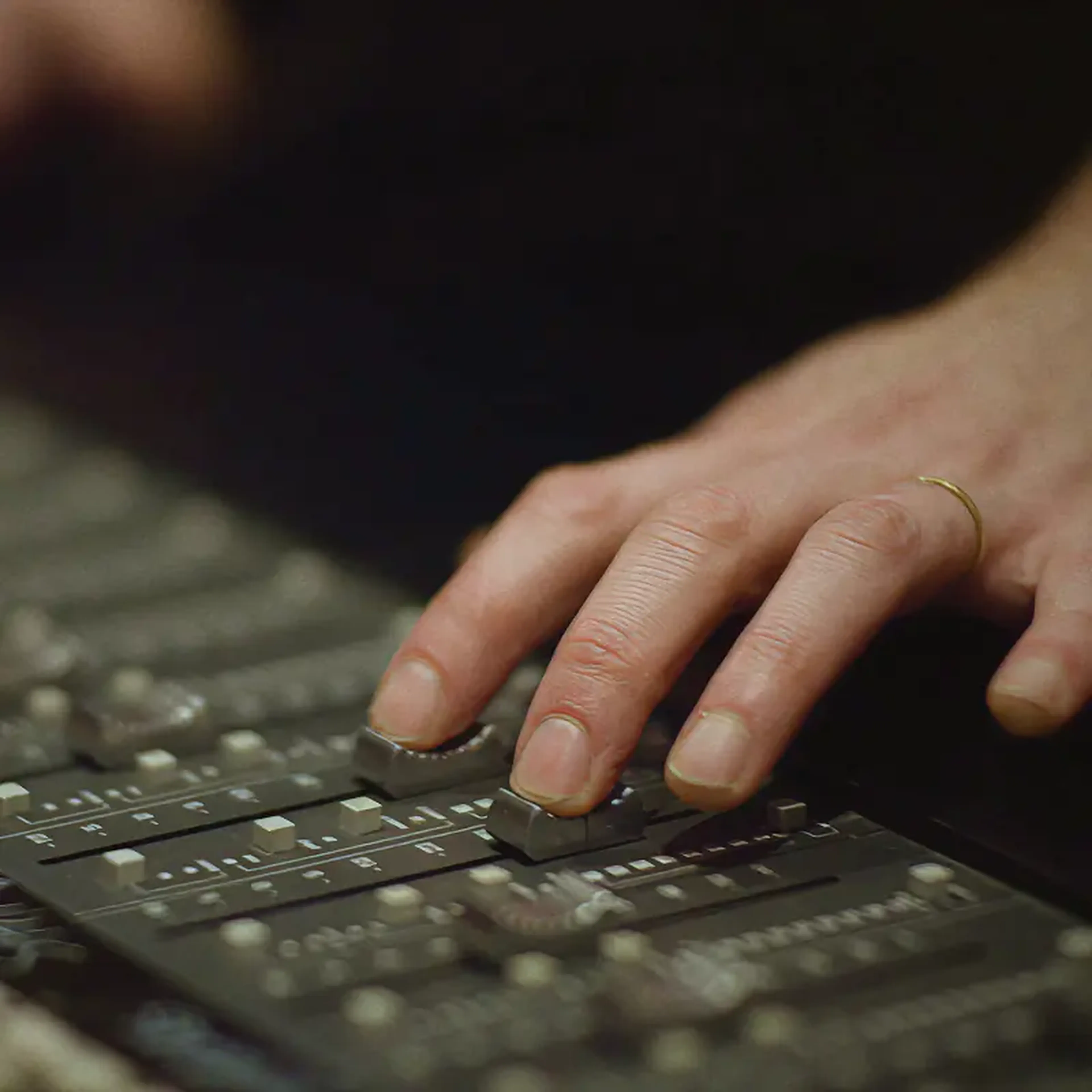 Hands of a sound engineer on a mixing desk, from the Sound of Leffe campaign