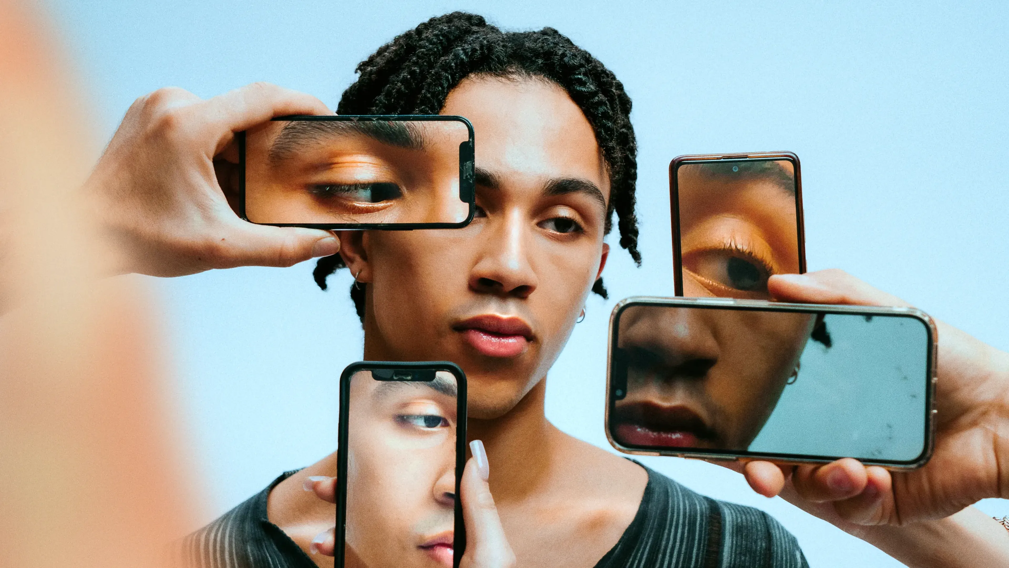 Creator's face framed by several smartphone screens, music for influencer and user-generated content