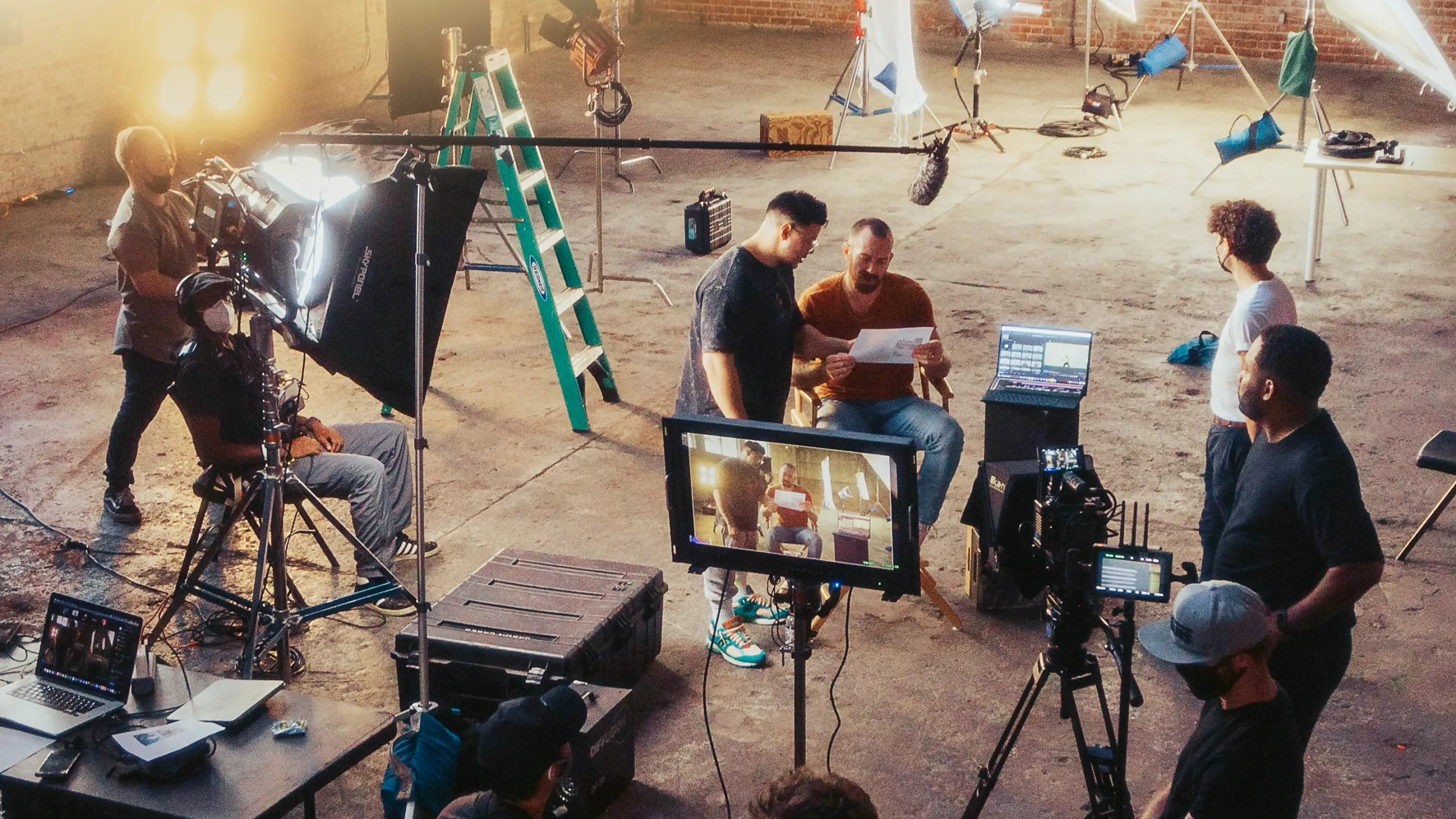 Film crew around a cinema camera and monitor on set, where MassiveMusic handles music licensing for film and TV