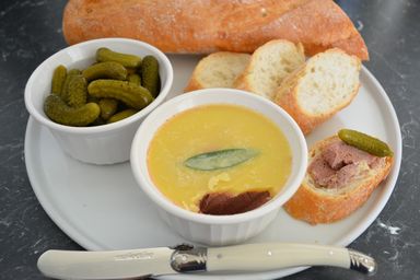 Chicken liver pate on platter with bread and pickles