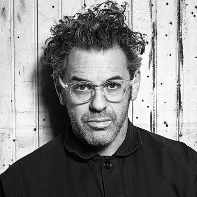 black and white, quite dramatic portrait of Tom Sachs wearing clear-framed glasses