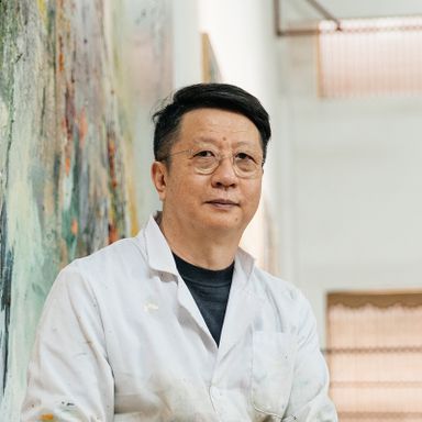 Wang Yan Cheng smiling wearing glasses and a white laboratory coat
