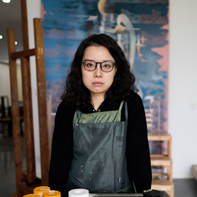 artist Cui Jie standing in her studio
