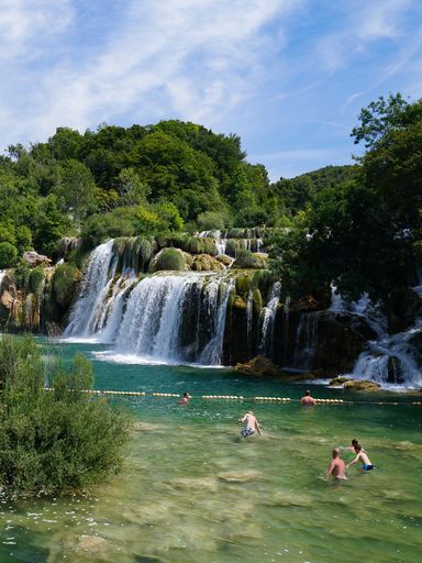 Swimming beneath the waterfalls in Krka National Park