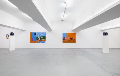 Two paintings hanging in a gallery space