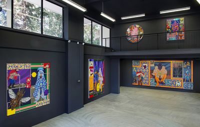 installation view of a large exhibition space with large-scale paintings hung on black walls